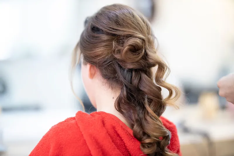 Close-up of an elegant bridal hairstyle featuring curls and a braid, captured from the back